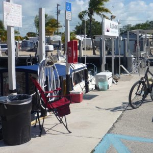 We turned our slip area into a ghetto with bicycles coolers grill. I used our induction cooker on the fish table which was equipped with an 120 volt outlet. Free ice over at the gray building in the backround