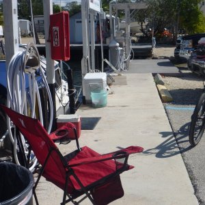 We turned our slip area at the dock to our home for the month. Note grill extra fish cooler to swap out with food cooler on the boat when fishing. Bucket for washing boat coolers and truck Out standing fish cleaning table nearby. Also note our black truck close by for access to extra stuff we don't need on the boat all the time.
