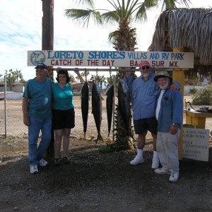 Our group with our yellowtails. The bottomfish are on the cleaning table to the right of us.