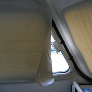 Leading edge of large side windows needs folding back when rolled up.  This leaves a crease but we aren't that picky