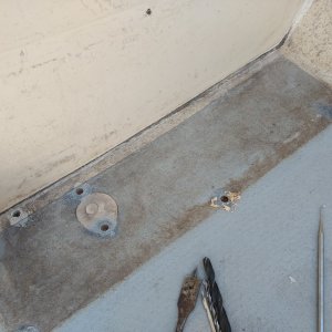 Since none of this stuff had been touched for the past 31 years, and I was getting a tiny bit of water seepage from the cockpit to the cabin, I decided to recaulk the deck/bulkhead seam. While I was at it i figured I may as well over-drill and epoxy fill the screw holes for the bilge pump and and pump cover.