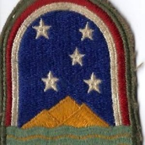 World War II Army Patch.  Not exactly related to boating, but it represents an Island that in order to travel there used to be only via water.  My great uncle served there from 1943 through 1945. It's Ascension Island. The stars represent the constellation Southern Cross. The Three Sisters mountains on the island are represented.