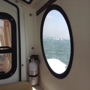 A picture of the Irish Queen taken through the iconic, round window of the Marinaut 215, Betty Ann