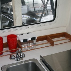 Inspired by others - galley rack made with 2 1/2" wide oak with two 3/8" dowels running the length.
