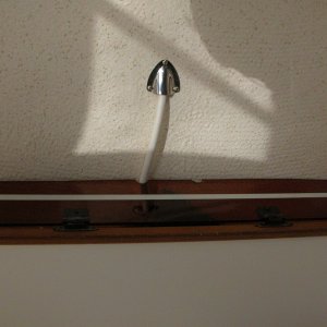 Cabin shelf viewed from below . The RADAR power cable is off center as it passes over the shelf. A second notch was equally placed off center to starboard as a finger hole to pull down and open the door.
