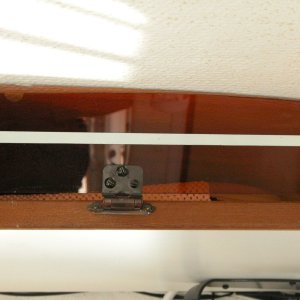 Close up view of hinge and its brass hardware.