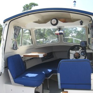 Inside, The added upper storage shelf w/tide clock is great for charts and misc. items. a lockable storage compartment under the helm seat, great for storing electronics etc.A Garmin 440 s Chartplotter and West Marine Windshield washer, much needed!