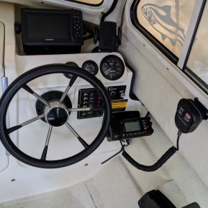 Showing Chartplotter, VHF, VHF mike, and cell phone holder.