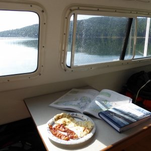 Breakfast and reading - The Curve of Time and the Dreamspeaker cruising guide