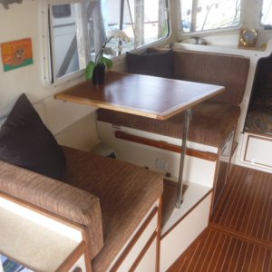 Port side w/ new table to compliment flooring, woodwork & new upholstery.