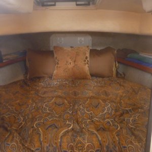 V-berth with custom memory foam matress & bedding, hypervent under matress, walls insulated with closed cell foam & lined with tan carpet/headliner.