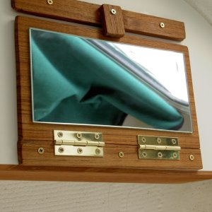 Vanity mirror: in folded mode, secured to bottom of shelf.