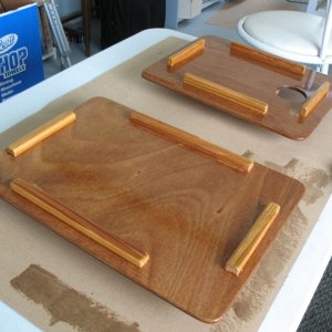 Making a set of "usable mock-up from scrap" cover boards for the sink and former-Wallas hole in the galley counter.  Two sheets of scrap 1/8" ply epoxied together to make 1/4", then cut and cleats affixed to the bottom side to hold them in place, and then varnished.  Turns out they make sort of handy "butler's trays" when used upside down at anchor.