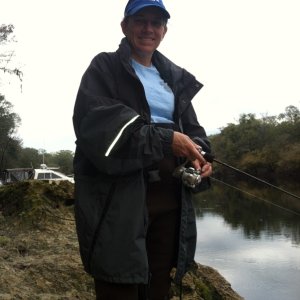A break in the rain. Waders, jacket and cap. This girl likes to fish!
