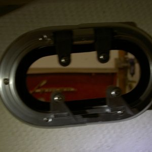 Add trim ring and secure with screws that cause the porthole to clamp to the trim ring.  Screws are not provided.