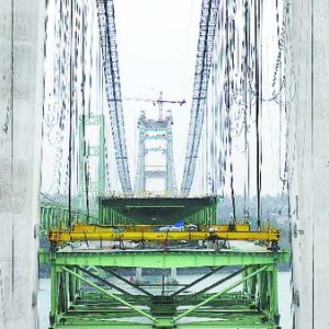 This picture is from the local paper and shows one of two sections that will slip between the two towers. The towers inside width is 1 1/4 inches wider than the bridge deck!