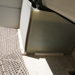 This photo shows the original fuel tank installation on a 2002 22 Cruiser.  These are 25-gallon tanks (not Moeller brand).  As you can see, they come forward slightly past the splashwell, thus the cover panels only run up about 7/8 height.  Somewhat interestingly (in a leverage sense), the straps that run over the tanks run from the top of the cover panel over the tank and down to the sole behind the tank at the transom.  With my new tanks I'm switching this around, so the strap runs from the bottom/sole at the forward side of the tank to the transom near the top of the tank.  Thus the cover panel will not be involved (also the newer, 23-gallon tanks will tuck "behind" the splashwell and allow for full height covers).  See more about installation in next photo.