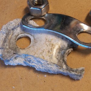 Here is what was under the skimpy SS backing plate.  Just compacted aluminum dust.  Turns out that the transom in this area is solid fiberglass, so the electrolysis was simply from using aluminum and SS together in a marine environment.  The other side wasn't as bad, but it also was fixed.