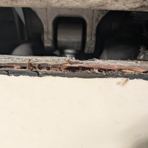 Transom beneath main motor mount, with cap removed. Rotten wood picked out for investigation.