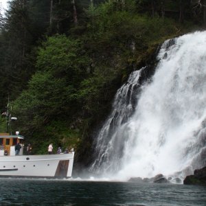 Discovery nosing into the Red Bluff Bay main attraction waterfall