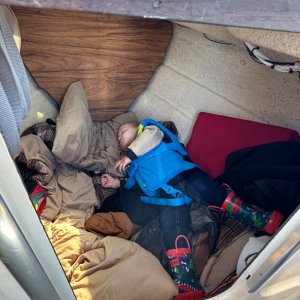 Grandson taking a nap up front in our 16' Angler!