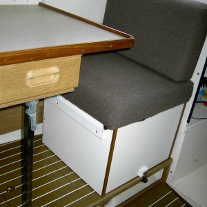 Dinette and seat in the standard forward position and locked in place. Also shows open storage for hose, electric cords, etc.