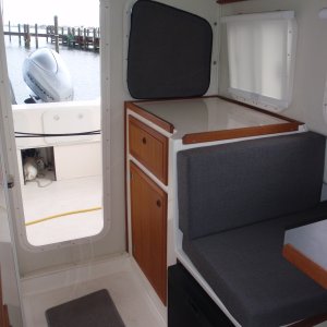 Lg storage cabinet w/drawer, side roller curtain, aft velcro attached window cover, cushion colors, rolled up cockpit doorway curtain