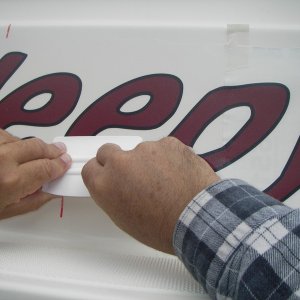 Smoothing the bubbles out from under the decal.  A credit card would work for this part too.