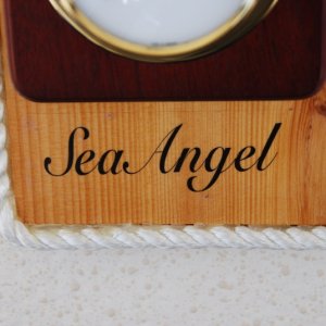 Vessel name was printed with MS WORD on a 'Clear Shipping Label', 11/2"x41/8", by AVERY. It was set in place and sprayed with a clear acrylic spray that you can get at any art supply or hardware store. The 3/8" line was hot glued to the base's outer edge.