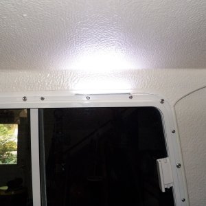 The have double sided tape on them and are the same width as the aluminum window frame.  I used a creme colored stick on conduit to make the wires disappear.