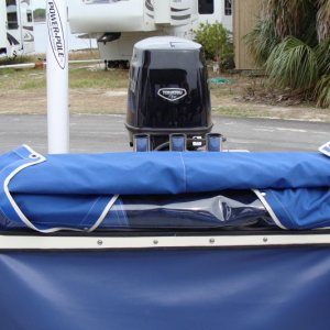 cover rolled and stored still attached
to back of lazerette