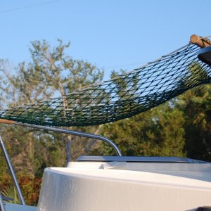 Hammock attaches to roof rails and bow rail.