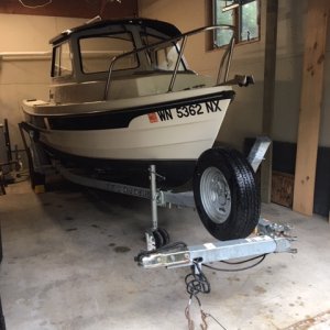 Yeah she fits! 2008 16 angler tucked in garage. Trailer tongue folded leaves 6 inches of lengthwise clearance.