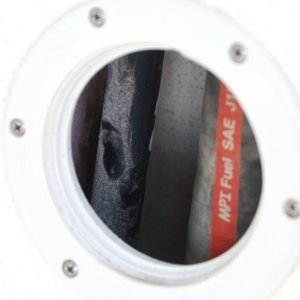 Starboard cockpit acces to fuel fill ( with red stripe) and vent lines.