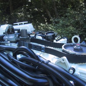 With timing marks properly aligned, remove belt, install new one, and reassemble.
Flywheel installs with notch on keyway on tapered shaft. Belt tension pulley has spring loading for belt tension, over tension can damage oil pump drive at bottom of cam shaft.