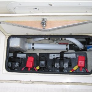 Batteries are installed below the deck hatches to keep weight low and free up storage space in transom - house bank shown.  Solenoid operated battery switches are remotely controlled from the helm station.  Truss mounted to underside of deck hatch improves seal by  preventing ends of hatch from springing upwards.  The truss is designed to bend the ends of the hatch downward about 1/16" which flattens out when dogged closed.