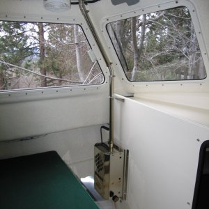 (Sea Skipper) Taylor?s pressurized kerosene heater, no electric power required - utilizes 1? flue.  Fan mounted aft of flue can be aimed to direct a warm blast of air clear across the forward windows for demisting.