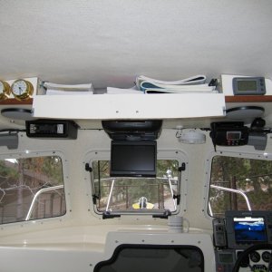 (Sea Skipper) Overhead chart storage, with weather instruments located each side.  Speakers installed vertically in separate enclosures, with the sides attached to roof to help support shelf.