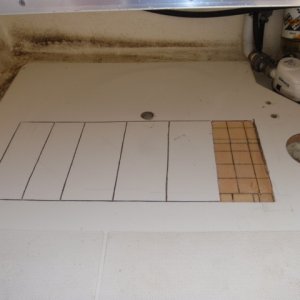 Hole for deck plate to the right.  Factory hole to insert foam under the cockpit floor on top.  The area of the cockpit floor that I opened up hoping to dry out the core, in the center.