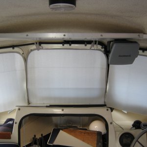 Windscreen covers up to keep the cabin cool at the berth. She faces east so the sun beasts on the windscreen half the day. Finally put that shelf back up ONLY to relocate the chart plotter......haven't hit it too bad yet....