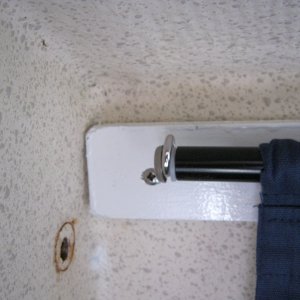 Here is the end of the curtain rail, a screw eye into the wood followed by a screw and finishing washer screwed into the end of the curtain rods works like dream. How did a screw it it? Held the screw with plyers and rotated the curtain rail. Took me a while to figure that one out!