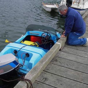 Harvey checking small boat.  This has got to be the smallest with the most power.  This one had two on board when they came into the dock.