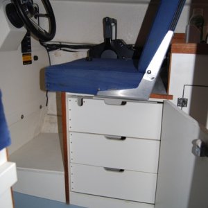 Custom cabinet and drawers under the helm seat.
