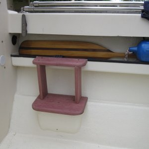 My solution to the big step in getting in and out of the cockpit.  Added a second step attached to tray below gunwale and supported by two vertical members.  Wood is purpleheart which is one third price of  teak and weathers to look like teak.