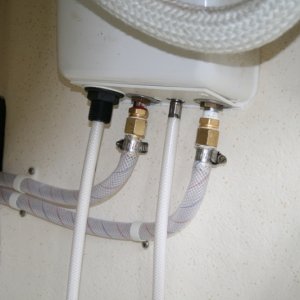 Shower hoses (under galley cabinet) showing new fittings