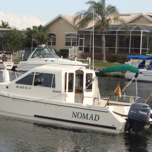 Flag poles are installed in angled fishing rod holders.  The staffs are 48" long, so they are 42" out of the transom.