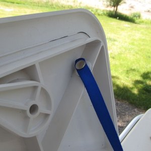 Strap is attached to hatch with snap stud that has a disc of 3M VHB tape on the back (they come this way).  I could also have through-fastened.