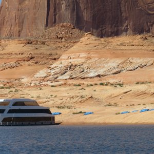 For a fee, you can have a service place water bags on the shore for securing your houseboat.