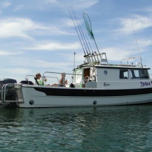 Starboard - good view of scuppers, swim step (ladder deployed), diamond plate throttle mount for cockpit helm controls