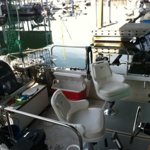 Cockpit - Plenty of space, even with four crab pots and the cooler. The two large hatches under seats lead to space extending  half again as far aft. Deep enough to fit several 5 Gallon totes each.
